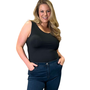 Blonde model wearing black tank top and blue jeans smiling at camera